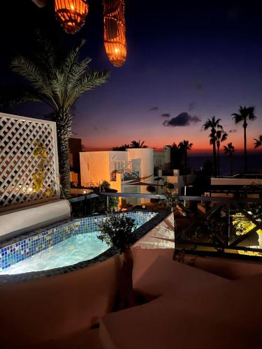 a night view of a swimming pool on a building at Sunset Deluxe Villa and Studios in Paphos
