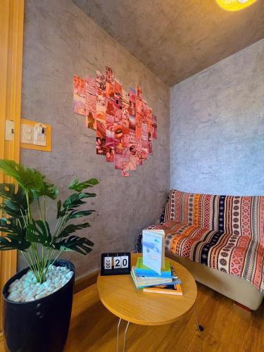 a living room with a couch and a table at MIS HOSTEL Cần Thơ in Can Tho