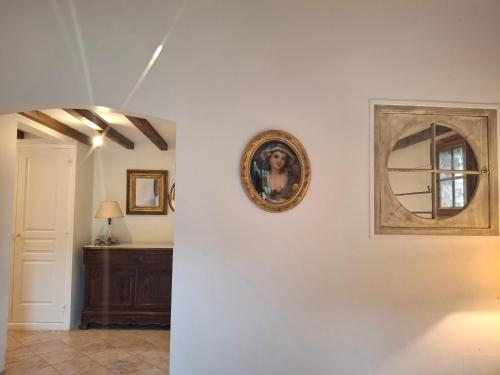 a hallway with a mirror on a white wall at La Bergerie in Saint-Raphaël