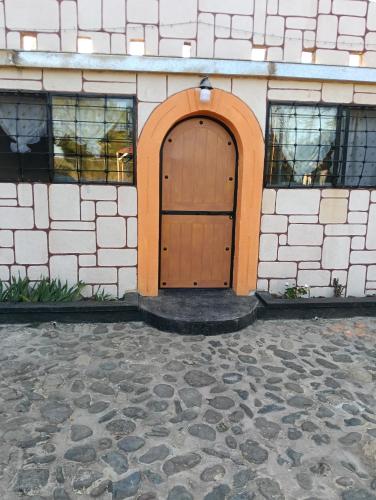 a wooden door on the side of a building at LA HUERTA Cabaña y Hospedaje in Huasca de Ocampo