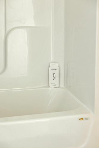 a white bath tub with a timer in a bathroom at Spacious Freshly Renovated Townhome - City Side in Loudon