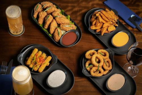 a table topped with plates of food and onion rings at Courtyard by Marriott World Trade Center, Abu Dhabi in Abu Dhabi