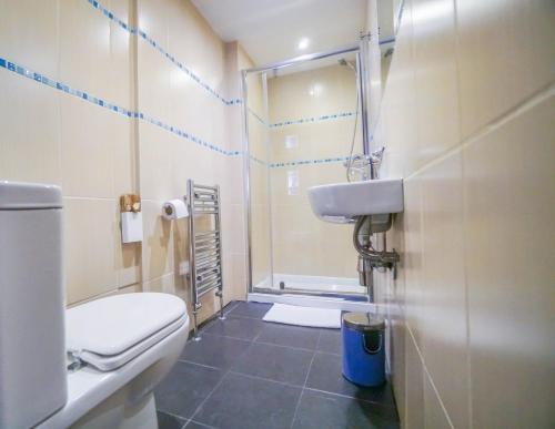 a bathroom with a shower and a toilet and a sink at St Athans Hotel in London