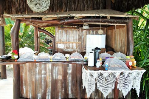 a food stand with a table with food on it at Pousada Mediterraneo in Barra Grande