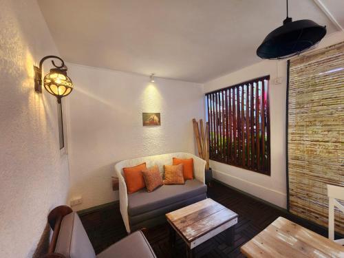 a living room with a couch and a table at The Rustic Vintage Suite in Grand Baie