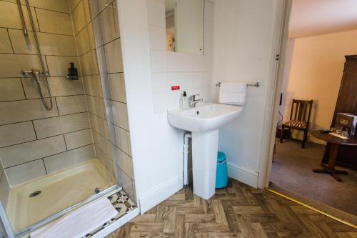 a bathroom with a sink and a shower at St Athans Hotel in London