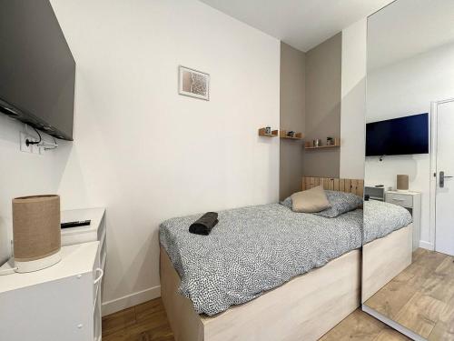 - une petite chambre avec un lit et une télévision dans l'établissement Studio le Glinglin - proche gare, à Saint-Brieuc