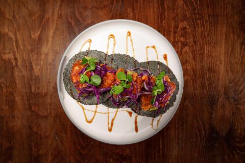 a plate of food on a wooden table at Azulea Bacalar Hotel & Spa - Lagoon Front in Bacalar