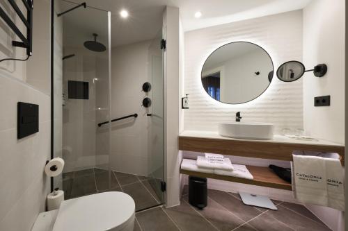 a bathroom with a sink and a toilet and a mirror at Catalonia Park Putxet in Barcelona