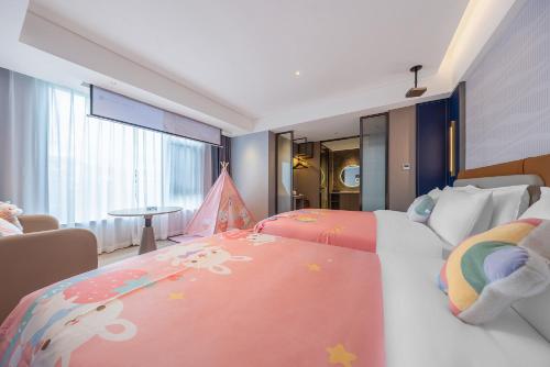a hotel room with two beds and a childs bedroom at Lijiang OKDAY HOTEL in Lijiang