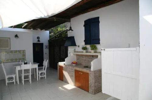 a kitchen and dining room with a table and chairs at Con i piedi nell'acqua in Stromboli
