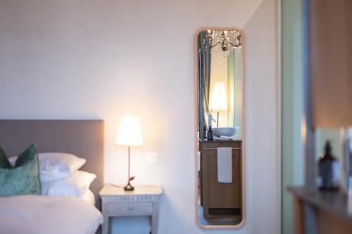 a hotel room with a bed and a mirror at Château Salavaux in Salavaux