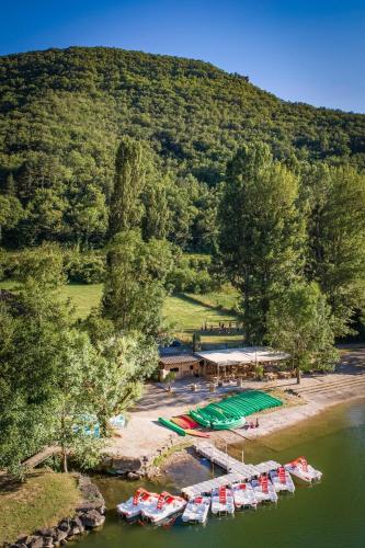 an aerial view of a dock with boats in the water at Camping de la Base Nautique in Saint-Rome-de-Tarn