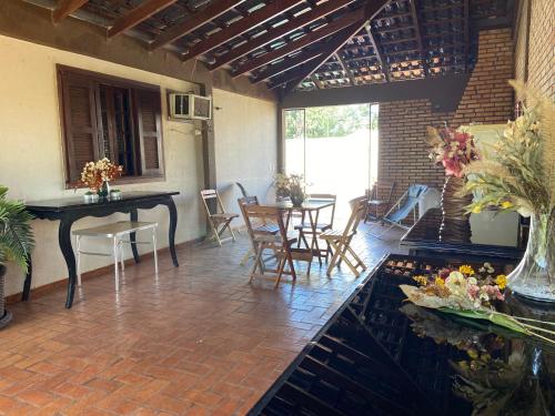 a patio with a table and chairs and a dining room at The House Foz Do Iguaçu Cataratas e Paraguai in Foz do Iguaçu