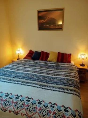 une chambre avec un grand lit avec deux lampes dans l'établissement Vacances face à la mer!, à Guidel