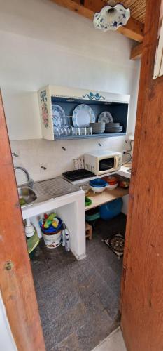 a kitchen with a sink and a counter with dishes at Nicaredda in Stromboli
