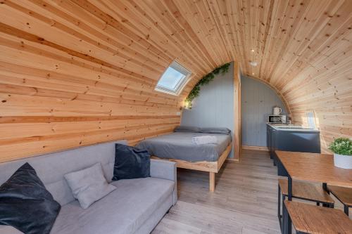 a room with a couch and a bed in a wooden ceiling at Wyke Lodges - Pod 2 in Guisborough