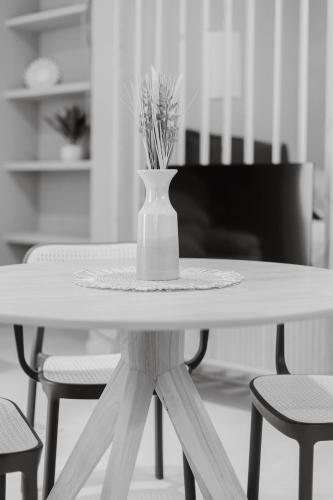 a white table with a vase on top of it at Apartamento Don Marcos B in Badajoz