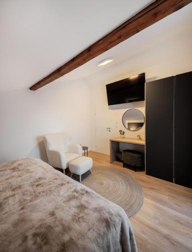a bedroom with a large bed and a desk at Eagle's View Villa in Batina