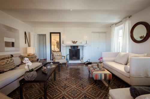 a living room with a couch and a fireplace at Luxe Villa, All Ensuites & Private Vineyard Views in San Marzano Oliveto