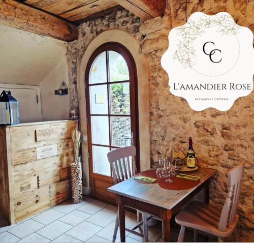 a dining room with a wooden table and a window at La Bergerie du Haut Var in Bargème