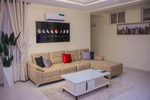a living room with a couch and a coffee table at Spacious One Bedroom MiniFlat Apartment in Lagos