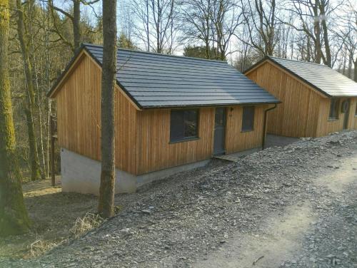 a wooden cabin in the middle of the woods at Au Bois Chantant in Somme-Leuze