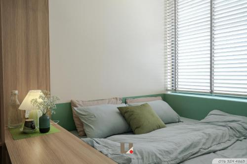 a couch in a room with a table and a window at Căn hộ du lịch tại Huế in Thôn Văn Dương