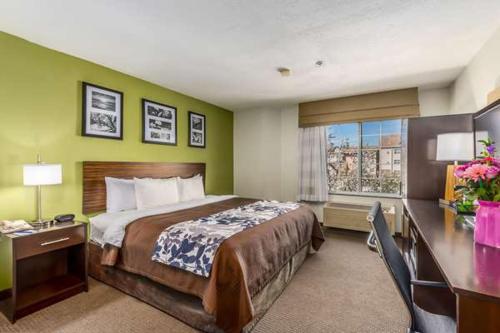 a hotel room with a large bed and a desk at Rodeway Inn in Albuquerque