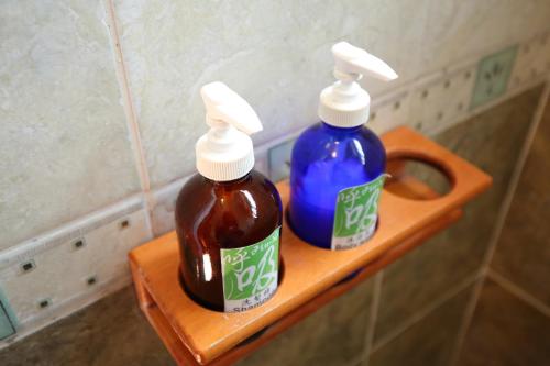two bottles of honey on a shelf in a bathroom at Huxi B&B in Jian