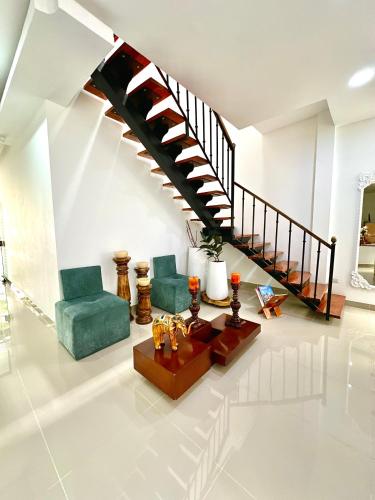 a living room with a spiral staircase in a house at Hotel Cafe Cafe Avenida in Armenia