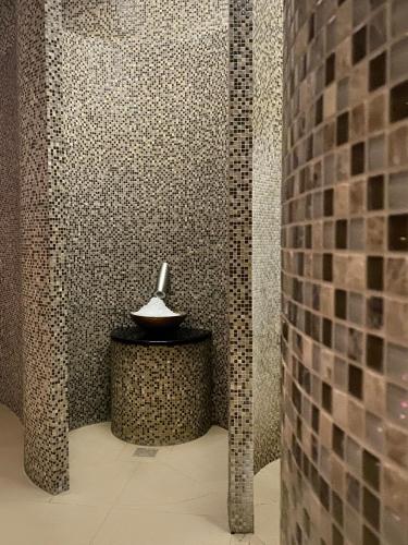 a bathroom with a shower with a bowl on a table at DoubleTree by Hilton Hotel & Conference Centre Warsaw in Warsaw
