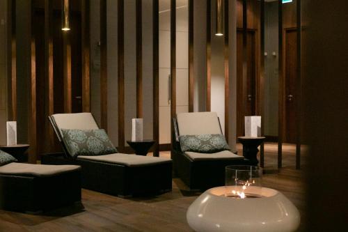 a room with two chairs and a table with a candle at DoubleTree by Hilton Hotel & Conference Centre Warsaw in Warsaw