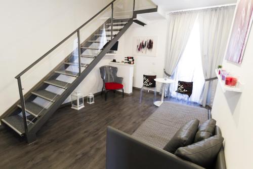 a living room with a staircase and a couch at Etna Suite Group in Catania