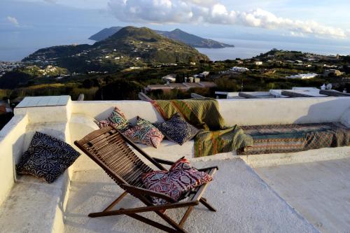 a chair sitting on a ledge with pillows at Villa Paradiso in Piano Conte
