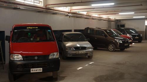 a group of cars parked in a parking garage at Kani Residency Hotel in Tuticorin