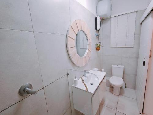a white bathroom with a sink and a mirror at OCEAN SHOREBREAK - Umdloti resort - Back up Water in Umdloti