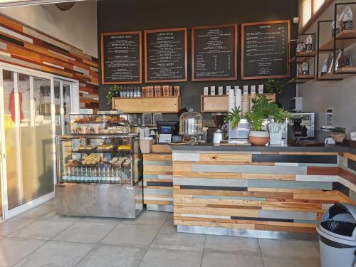 a bakery with a counter with pastries on it at OCEAN SHOREBREAK - Umdloti resort - Back up Water in Umdloti