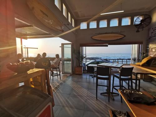 a restaurant with a view of the ocean at OCEAN SHOREBREAK - Umdloti resort - Back up Water in Umdloti