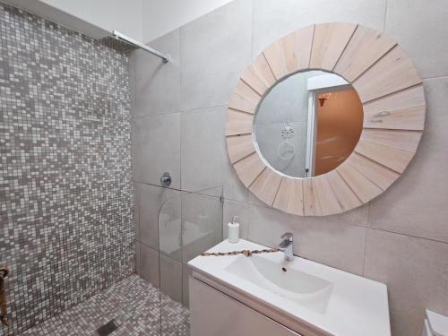 a bathroom with a sink and a mirror at OCEAN SHOREBREAK - Umdloti resort - Back up Water in Umdloti