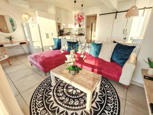 a living room with a couch and a table at OCEAN SHOREBREAK - Umdloti resort - Back up Water in Umdloti