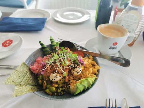 a plate of food on a table with a cup of coffee at OCEAN SHOREBREAK - Umdloti resort - Back up Water in Umdloti