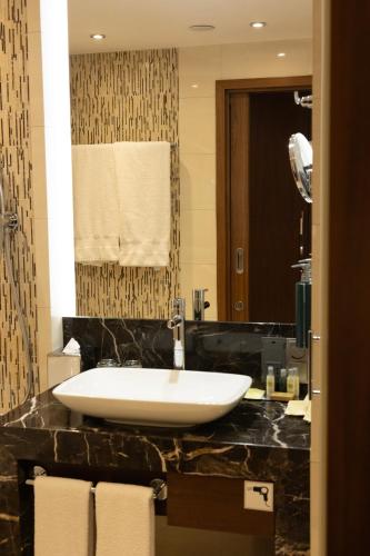 a bathroom with a large white sink on a counter at DoubleTree by Hilton Hotel & Conference Centre Warsaw in Warsaw
