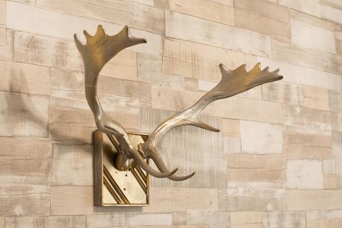a bronze deer head light on a wall at Villa Oliva Boutique Rooms Zamárdi in Zamárdi