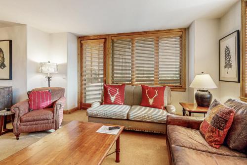 a living room with a couch and a table at Torian Plum Creekside 415 in Steamboat Springs