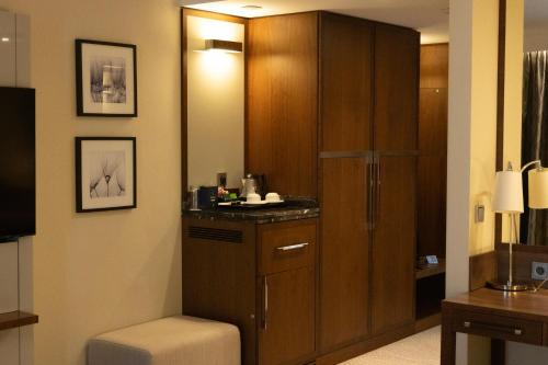 a bathroom with a cabinet and a toilet in it at DoubleTree by Hilton Hotel & Conference Centre Warsaw in Warsaw
