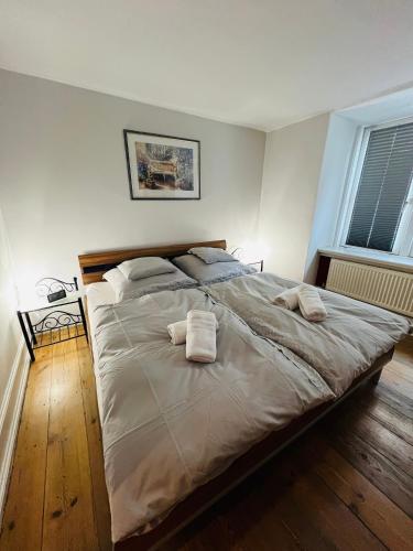 a large bed in a bedroom with two towels on it at Elvis Family Dream in Lübeck