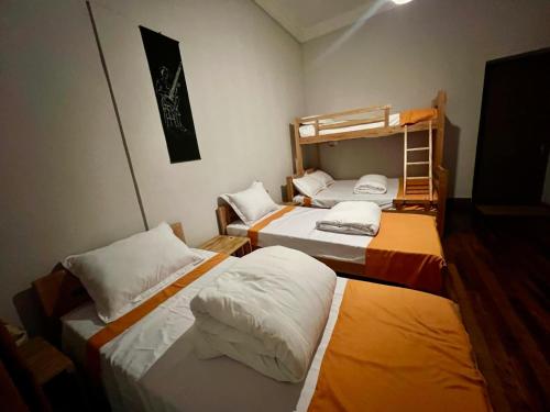 a room with three beds and a bunk bed at Soa Vahiny in Mandriankeniheny
