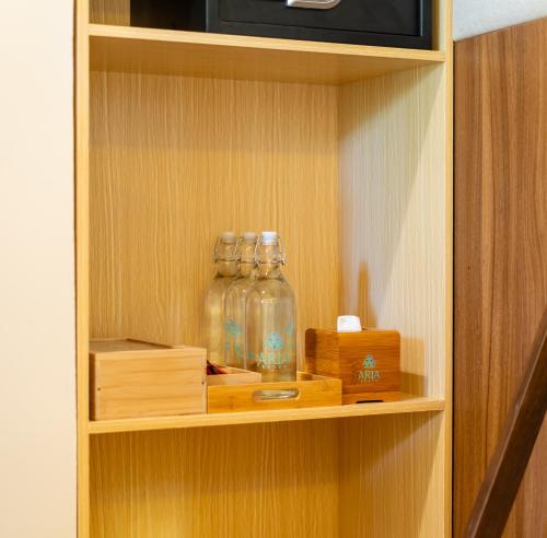 a cabinet with three glass jars on a shelf at ARIA Beach, Ukulhas in Ukulhas