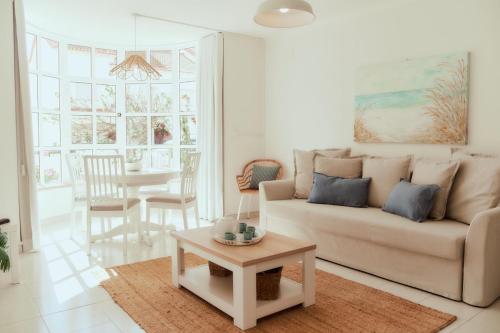 a living room with a couch and a table at Balili Beach House in Ferrel